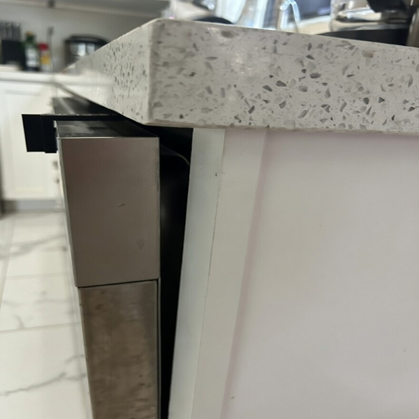 Dishwasher door held slightly open by V Latch for ventilation